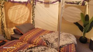 A bed or beds in a room at glamping in Dromineer