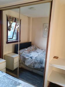 a bedroom with a bed and a mirror at Glasgow Millroad Private Room in Glasgow