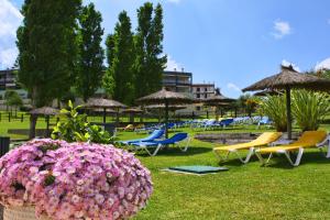 a group of lawn chairs and umbrellas and flowers at Marina Park 202 in Lagos