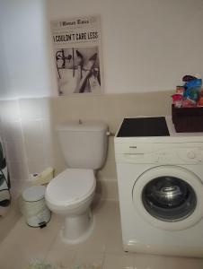 a bathroom with a toilet and a washing machine at Raxoni House in Skala Rachoniou +36 photos