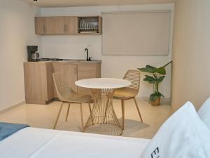 a kitchen with a table and chairs in a room at Elemont Hotel in Medellín