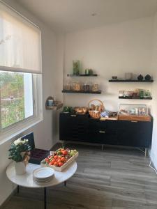 a kitchen with a table with a bowl of fruit on it at Hôtel Paradis in Bormes-les-Mimosas