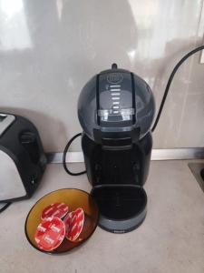 a black coffee maker with a bowl of red chocolates at Jacky's Apartament - Апартамент в Свети Влас in Sveti Vlas +45 photos