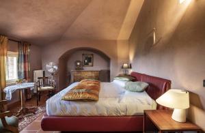 1 dormitorio con 1 cama y 1 mesa con lámpara en Villa Moglietta, en Albaretto Della Torre 