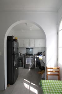 a kitchen with a refrigerator and a stove top oven at Casa Águila y Cóndor Miraflores in Lima