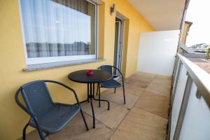 ein kleiner Tisch und Stühle in einem kleinen Zimmer mit Fenster in der Unterkunft Hotel Vulkan Residenz - Self-Check-in in Leibnitz