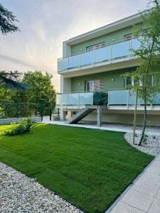 a building with a bench in front of a yard at Apartment ZANzi in Šamorín