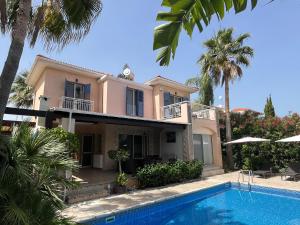 a house with a swimming pool in front of it at Lachi Marina Villa #17 in Polis Chrysochous
