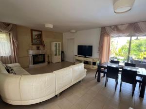 a living room with a white couch and a table at Lachi Marina Villa #17 in Polis Chrysochous