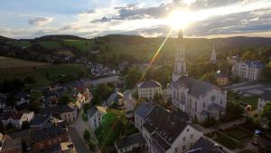an aerial view of a small town with a church at Ferienwohnung Schickolores in Eibenstock