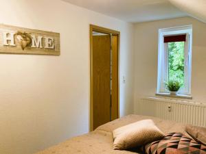 a bedroom with a bed and a window at Ferienwohnung Schickolores in Eibenstock