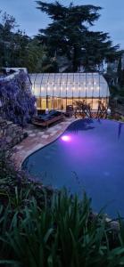 a swimming pool in front of a house at night at Villa Ardjoeno in Mandelieu-la-Napoule