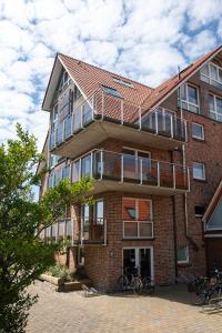 a brick building with bikes parked outside of it at Lee in Juist