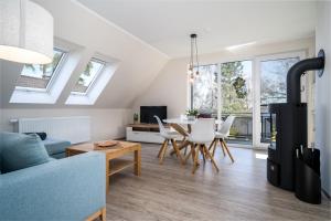 a living room with a blue couch and a table at Strandhaus 3 OG in Marienfelde