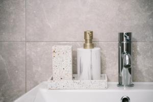a bathroom sink with a soap dispenser on it at The Rooftop of Apartments Lungo Mare in Ulcinj +95 photos