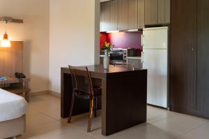 a kitchen with a kitchen island with a refrigerator at Tsokas Hotel in Finikounta