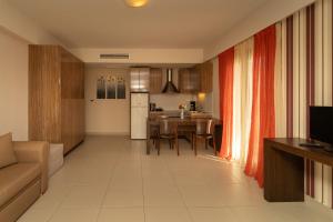 a kitchen and living room with a couch and a table at Tsokas Hotel in Finikounta