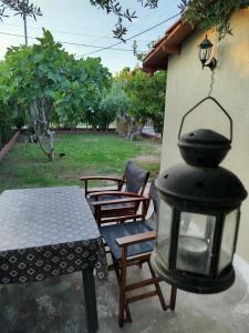 a lantern sitting next to a table and chairs at SELO APARTMENTS in Nea Kalikratia