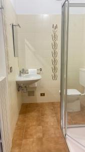 a bathroom with a sink and a toilet at Casa Blue lake in Gravedona +24 photos
