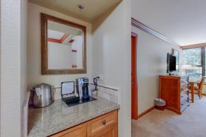 a kitchen with a counter top and a mirror at Resort at Squaw Creek's 605 in Olympic Valley