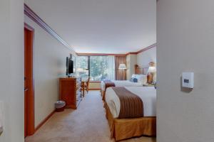 a hotel room with two beds and a television at Resort at Squaw Creek's 605 in Olympic Valley +20 photos