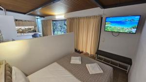 a living room with a flat screen tv on a wall at Black Goat in Chrysi Ammoudia