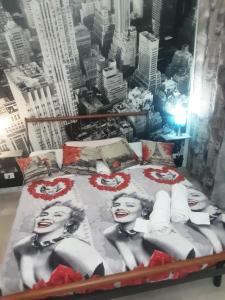 a bed with a picture of two women on it at Affittacamere da chris in Reggio Calabria