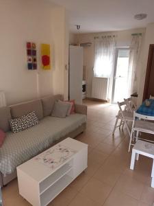 a living room with a couch and a table at Μεζονέτα 50m από τη θάλασσα in Skála Nikíta