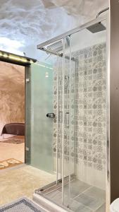 a shower with a glass door in a bathroom at Cave house in Heraklio