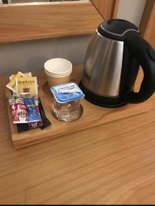 a tea kettle and a container on a shelf at Sümela Monastery & Hamsikoy Apart Hotel in Trabzon
