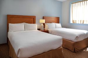 a bedroom with two beds and a window at Staybridge Suites Queretaro, an IHG Hotel in Querétaro