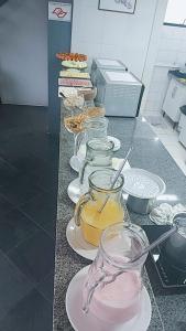 a counter with several jars and plates of food at Guida Residenza Pousada in Campos do Jordão