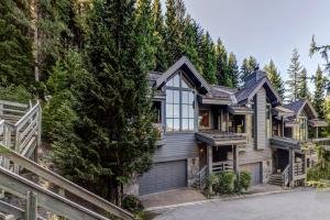 a house in the woods with a driveway at Northern Lights 21 in Whistler