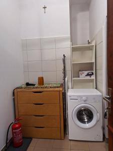 a laundry room with a washing machine and a washer at Za zieloną bramą in Zawiercie