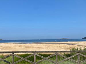 a fence on a beach with the ocean in the background at PRIMERA LINEA PLAYA AMERICA in Nigrán