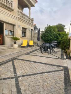 a group of chairs and tables in front of a building at PRIMERA LINEA PLAYA AMERICA in Nigrán
