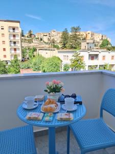a blue table with breakfast food on a balcony at Seaway Accommodation " Private Parking " in Tropea