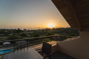 a balcony with a view of the sunset at Tsokas Hotel in Finikounta
