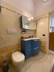 a bathroom with a blue sink and a toilet at Casa Elena - Centro Diano Marina in Diano Marina