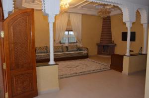 a living room with a bed and a window at VillaAbrajeimmo in Marrakech