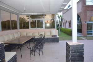 a patio with a couch and a table and chairs at VillaAbrajeimmo in Marrakech +31 photos