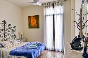 Un dormitorio con una cama con un edredón azul. en La Llar de la Kim, ideal familias, en Arenys de Mar