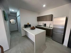 eine Küche mit einer weißen Theke und einem Kühlschrank in der Unterkunft Best option in Mazatlan in Mazatlán