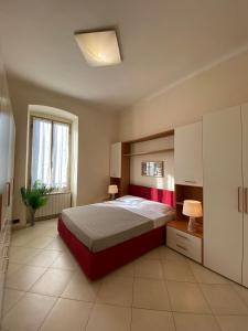 a bedroom with a large bed and a window at Casa Elena - Centro Diano Marina in Diano Marina +20 photos