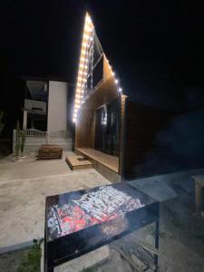 a building with a table in front of it at night at Cottage Eco house in Kobuleti