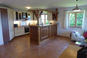 a kitchen with an island in the middle of a room at Ferienwohnungen Florian Pletzenauer in Gstadt am Chiemsee