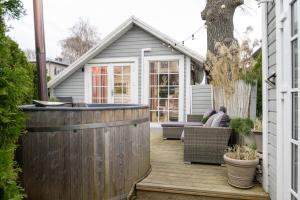 a backyard patio with a wooden fence and a shed at Guesthouse Delisa in Pärnu