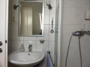 a bathroom with a sink and a mirror and a shower at WiW - Wohnen in Wathlingen in Wathlingen +7 photos