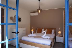 a bedroom with a bed with swans on it at Mosta Dome Penthouse in Mosta