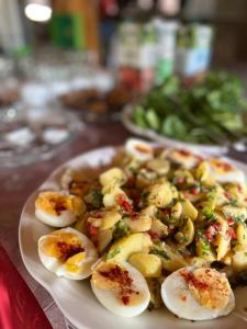 a plate of food with deviled eggs on a table at Olympos Yavuz Hotel in Cıralı +37 photos